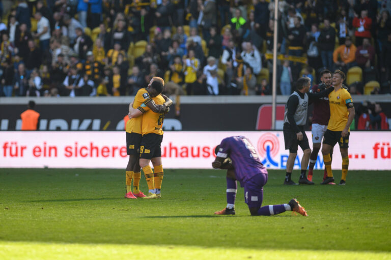 Dynamo feiert den Heimsieg, im Bild: Michael Akoto (links) und Paul Will (rechts), davon Maxwell Gyamfi (VfL Osnabrück). / IMAGO / Dennis Hetzschold