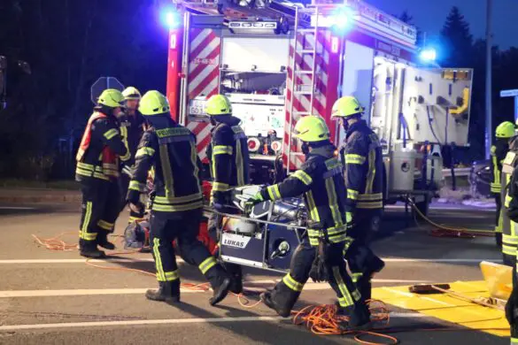 Feuerwehrleute tragen hydraulisches Rettungsgerät