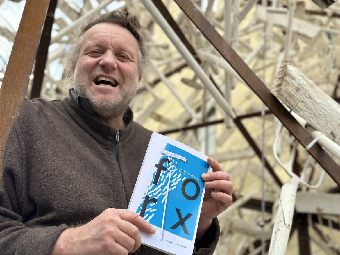 Volker-Johannes Trieb mit dem Begleitbuch zu „forx. pitchforks for peace“ / Foto: Pohlmann