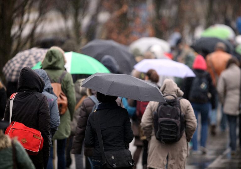 Menschen mit Regenschirmen