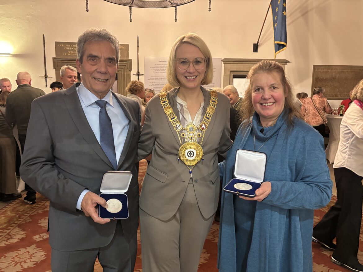 Gerd Bücker (links) und Diana Coppenrath (rechts) präsentieren ihre Bürgermedaillen, die Oberbürgermeisterin Katharina Pötter ihnen zuvor verliehen hat.