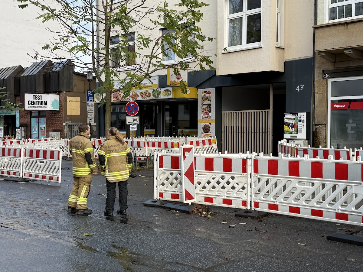 Feuerwehrleute warten darauf, dass die Kontrolle eines Hauses im Evakuierungsgebiets abgeschlossen ist